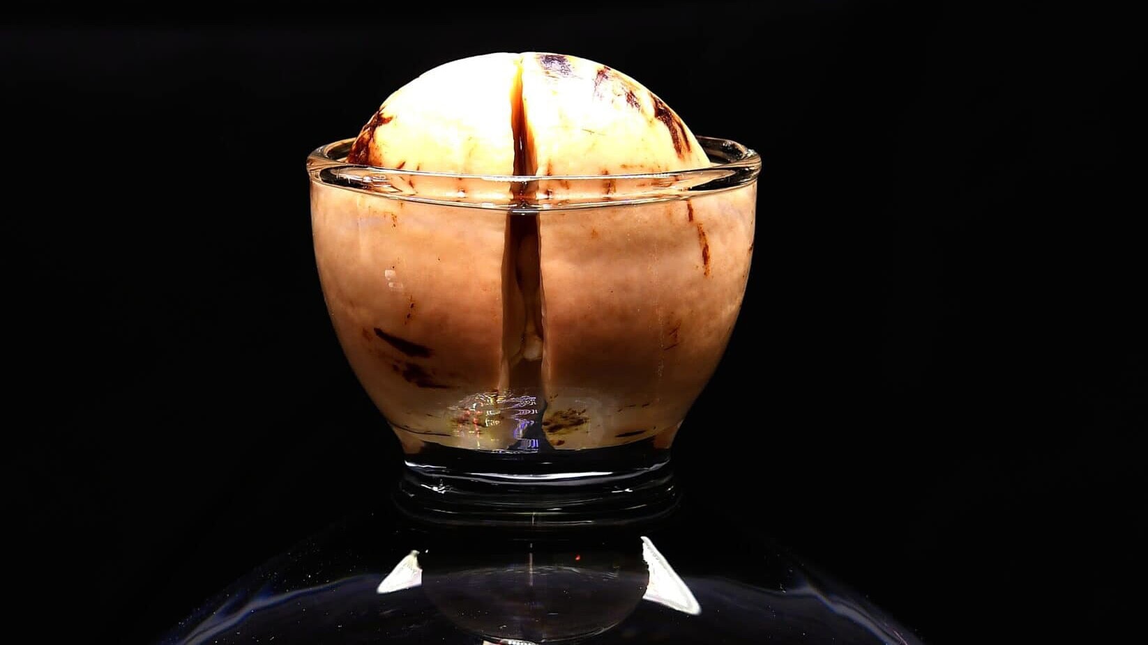 Avocado seed germinating in a jar of water on a windowsill