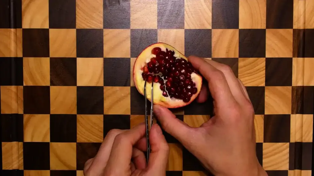 A single pale pomegranate seed wiped clean of its red pulp on a paper towel
