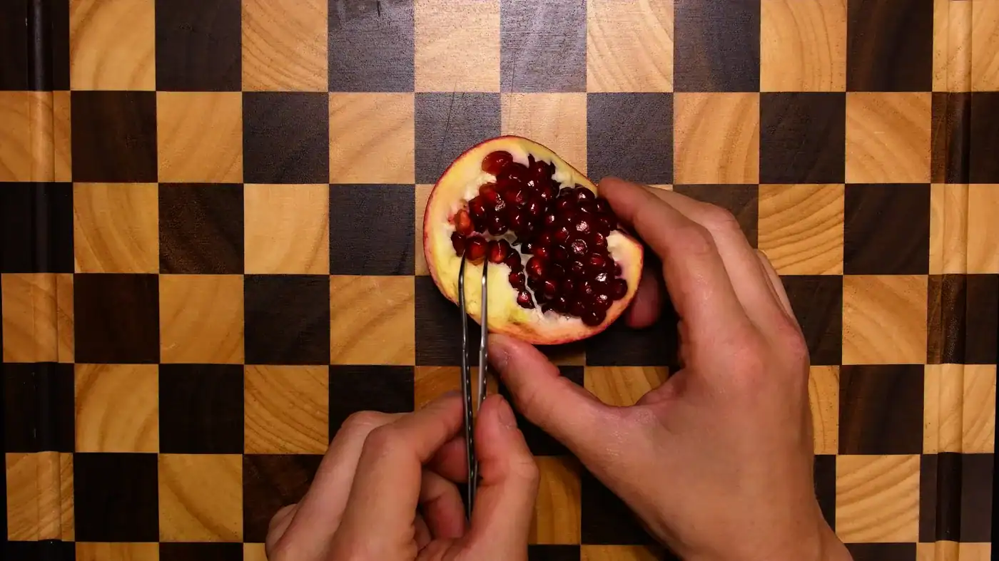A single pale pomegranate seed wiped clean of its red pulp on a paper towel